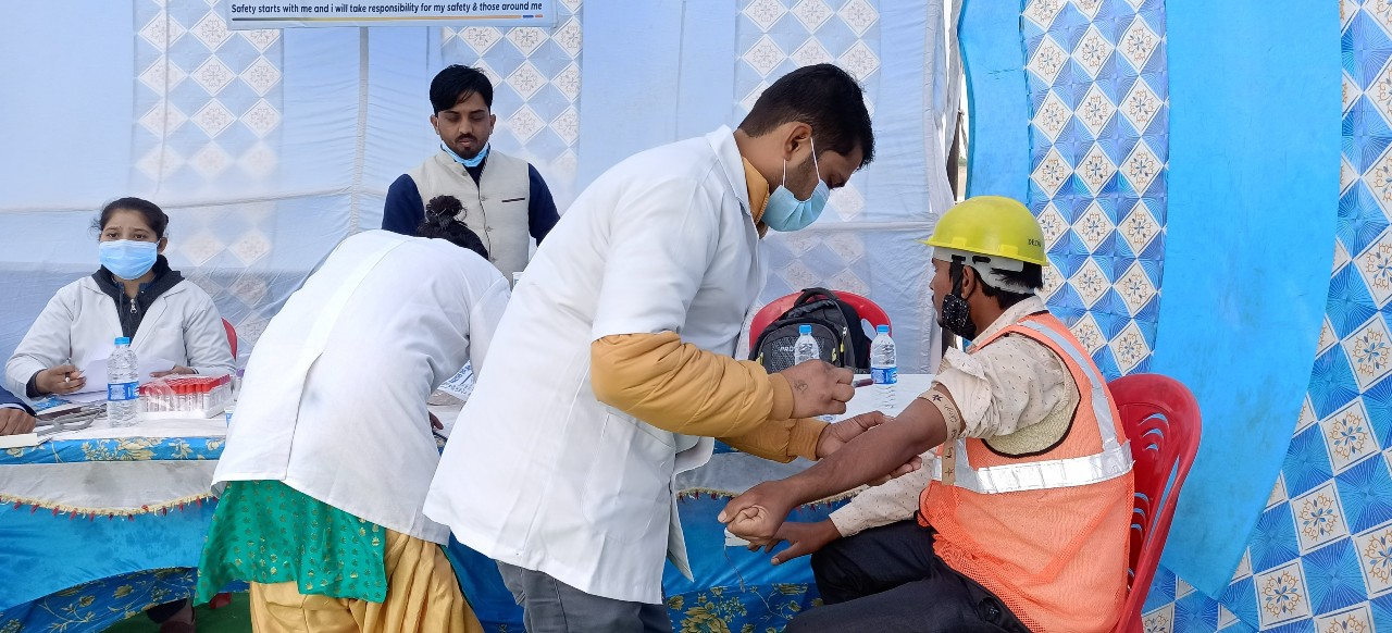 A doctor performing a health checkup for a worker